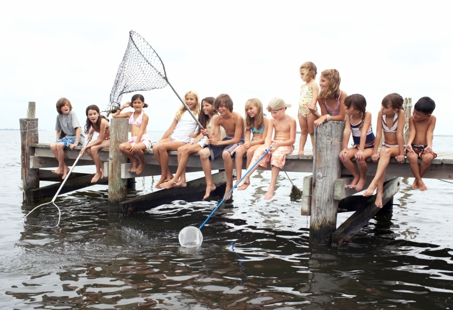 Group of children (3-12) fishing on jetty (Digital Composite)